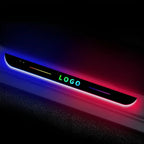 Black LED door sill plate with multi-color RGB lighting and custom logo for car protection.