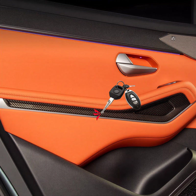Orange leather car door panel with carbon fiber trim and a car key resting on it.