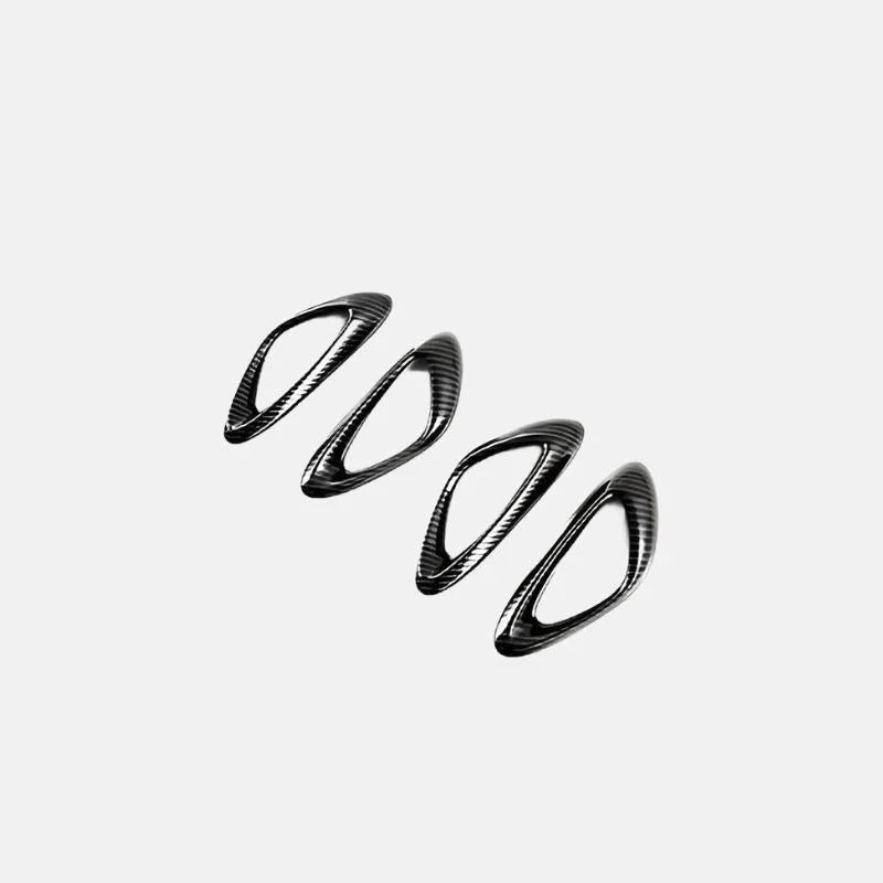 Four black carbon fiber patterned decorative trim pieces for BYD car interior.