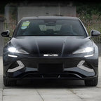 Front view of a sleek black BYD electric sedan featuring bright LED headlights and a glossy finish.
