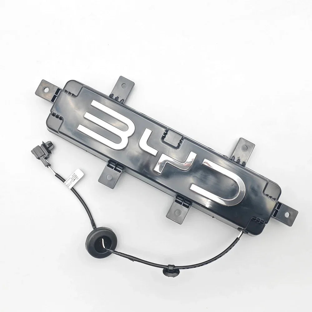 Black BYD emblem badge with polished silver chrome lettering and electrical wiring.