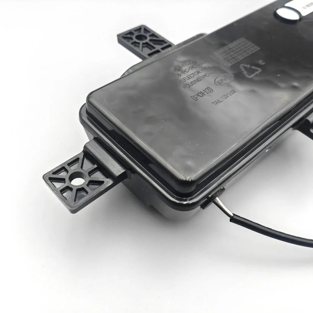 Black PC material automotive tail light housing with durable mounting brackets.