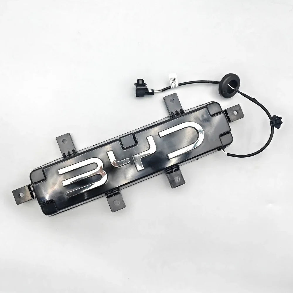 Black glossy BYD emblem trim with chrome lettering and integrated sensor wiring.