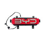 Red and black BYD emblem with chrome letters and electrical wiring for vehicle installation