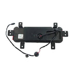 Black plastic automotive electronic component with integrated wiring and connectors.