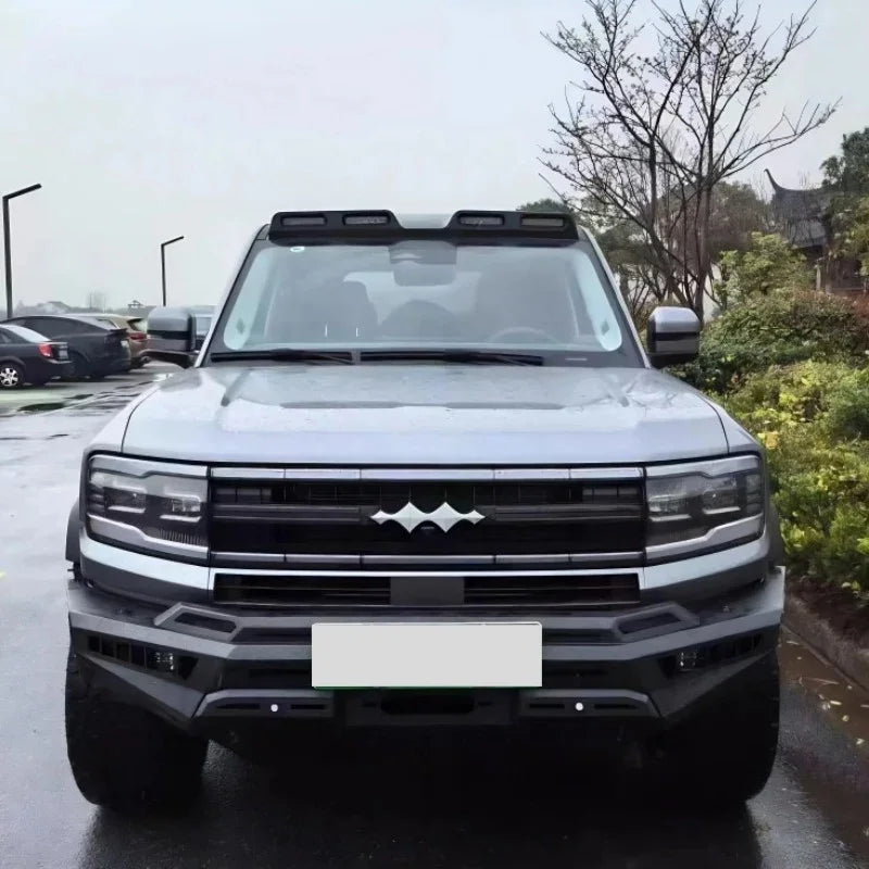 Silver BYD pickup truck featuring a rugged black front bumper and roof-mounted LED light bars.