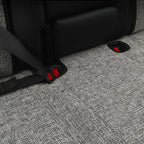 Close-up of grey textured fabric car mats with secure black straps and red locking clips.
