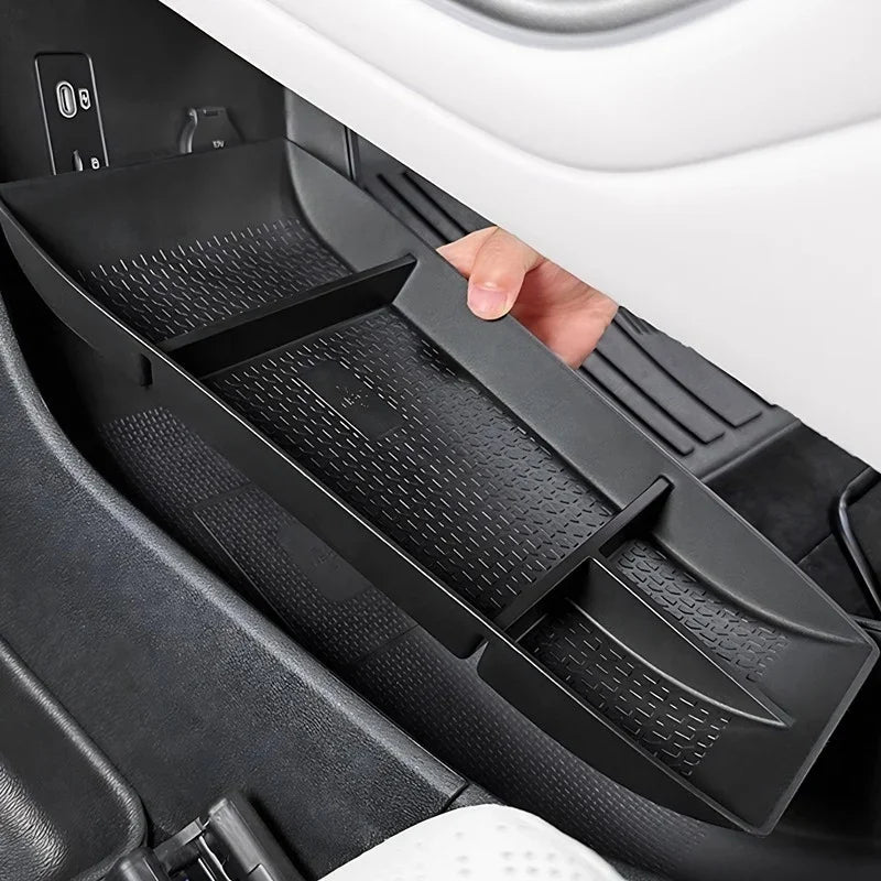 Black textured plastic center console organizer tray for car interior storage