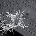 Water splashing on a black waterproof textured car mat made of durable synthetic material.