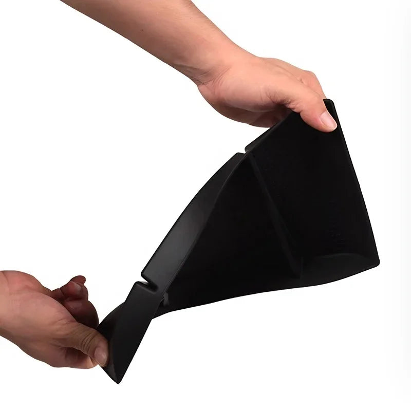 Hands holding a durable black flexible plastic car interior organizer tray.