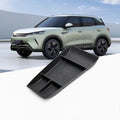 Black durable textured TPE center console organizer tray for a light green electric SUV