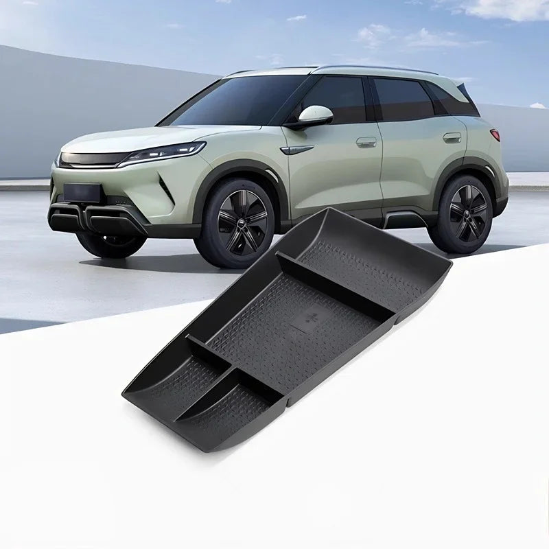 Black durable textured TPE center console organizer tray for a light green electric SUV