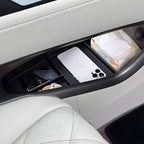 Black organizer tray in a white car center console holding a smartphone and facial tissues.