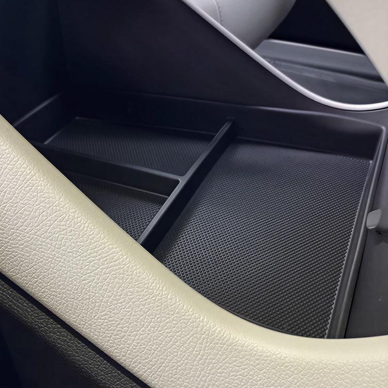 Black textured organizer tray installed in a car center console for efficient storage.