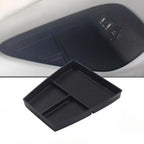Black plastic BYD car center console organizer tray designed for organized storage.