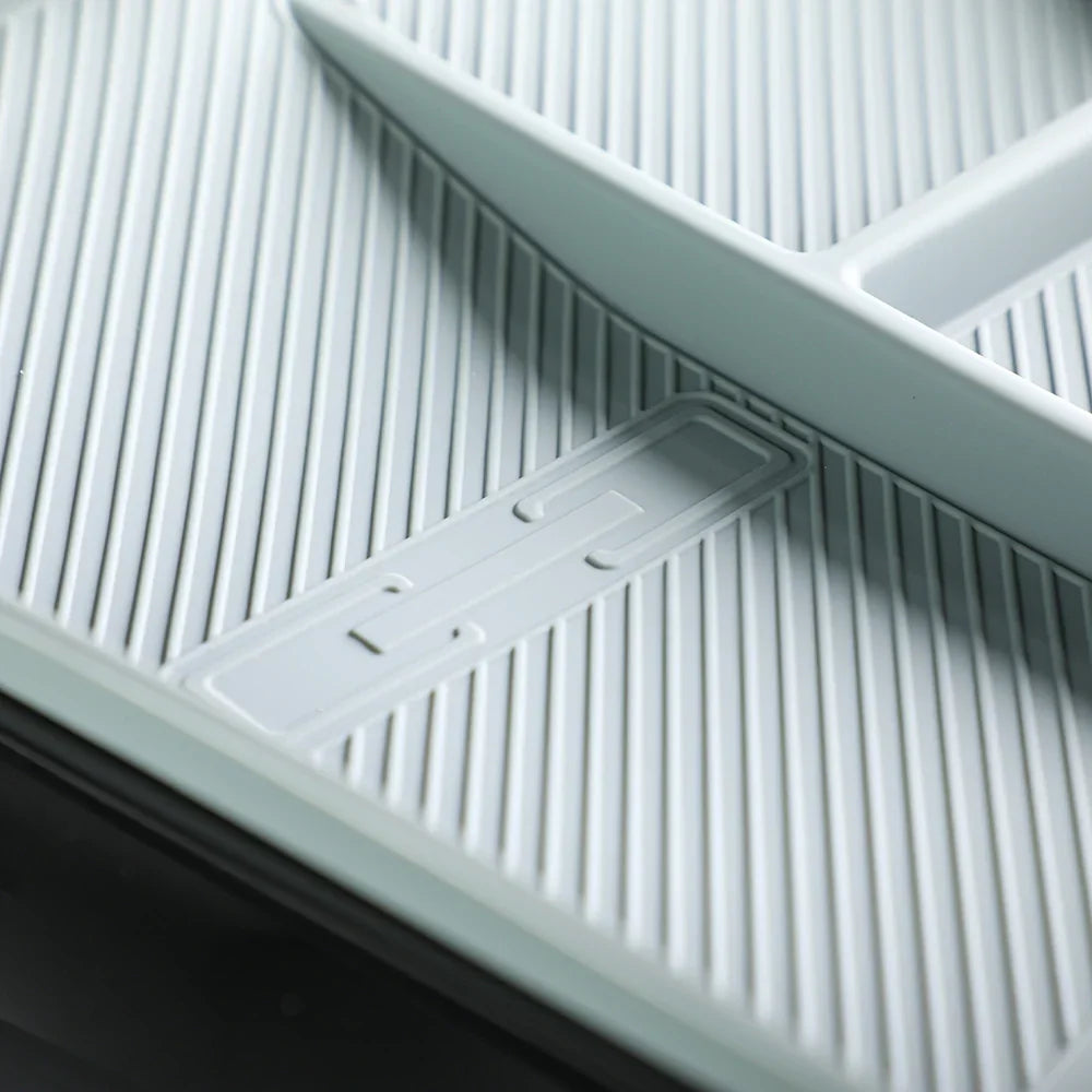 Grey textured TPE car floor mat with anti-slip ridges and integrated drainage design.