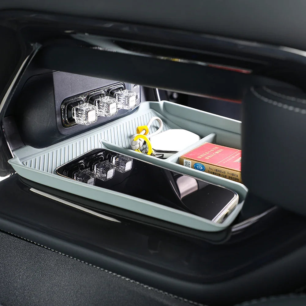Custom-fit grey silicone car console organizer tray with transparent storage compartments.