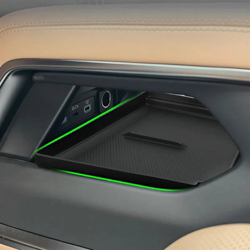 Black textured non-slip center console organizer tray with green LED ambient lighting.