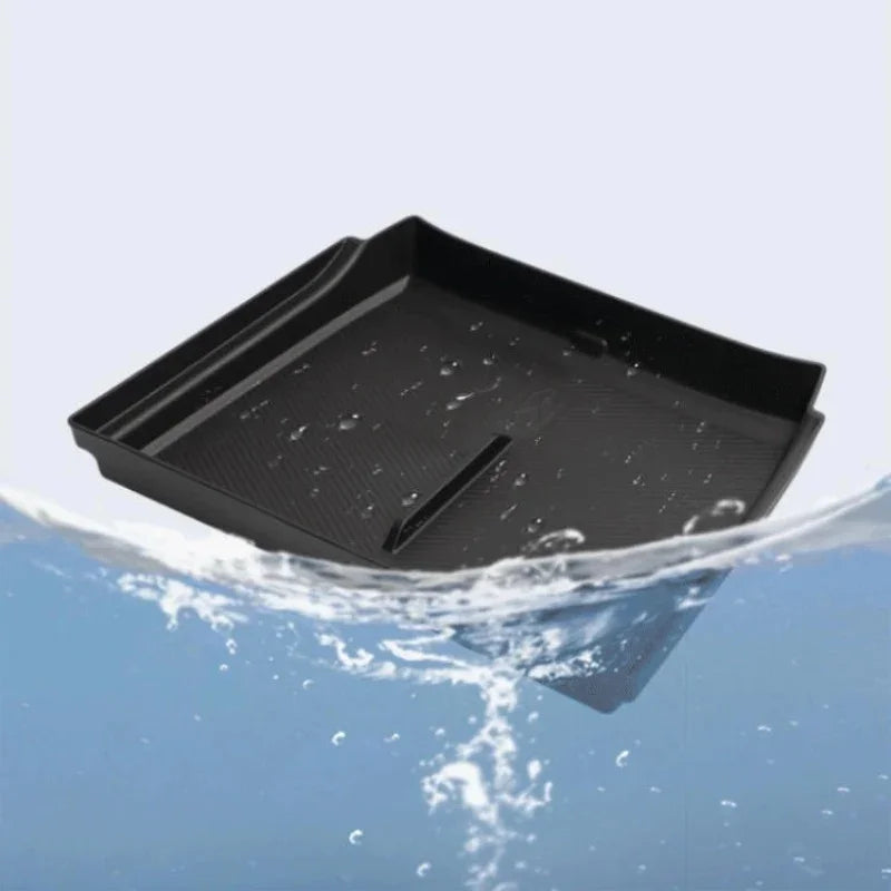 Black waterproof TPE car tray mat partially submerged in water, showing durable material.