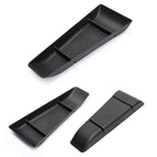 Black matte textured organizer trays for car center console storage.