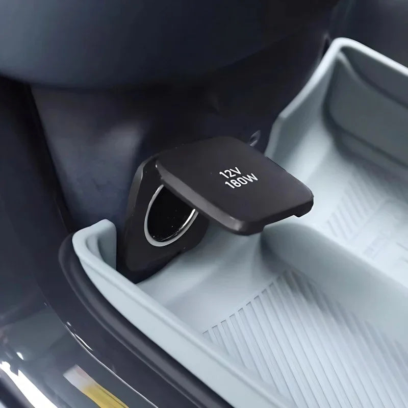 Close-up of a black matte 12V 180W car power outlet with a protective flip cover.