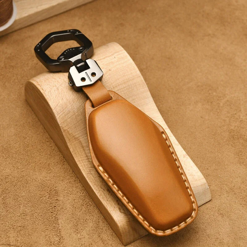 Premium tan leather key fob with heavy-duty black metal carabiner clip.