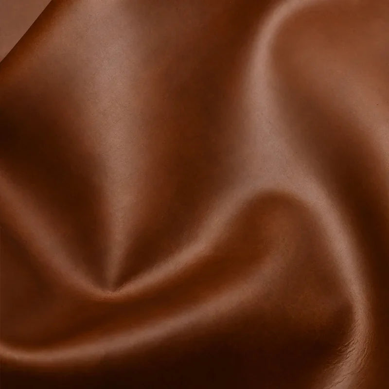 Smooth brown premium leather texture with a soft matte finish for car interior upholstery.