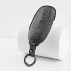Professional black grained leather car key cover with a durable metal ring.