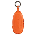 Premium orange textured leather car key fob cover with protective stitching.
