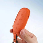 Orange textured leather car key fob cover for BYD accessories.
