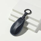 Professional navy blue leather car key cover with blue stitching and a metal keyring.