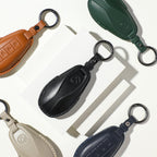 Set of premium leather car key covers in black, tan, green, beige, and navy blue.