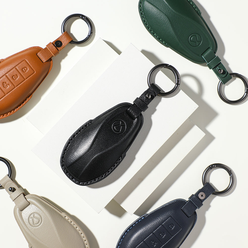Set of premium leather car key covers in black, tan, green, beige, and navy blue.