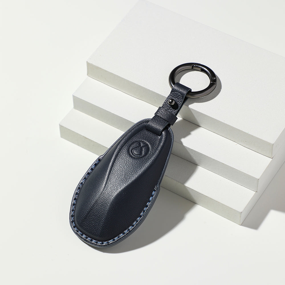 Premium navy blue textured leather car key fob cover with contrast blue stitching.