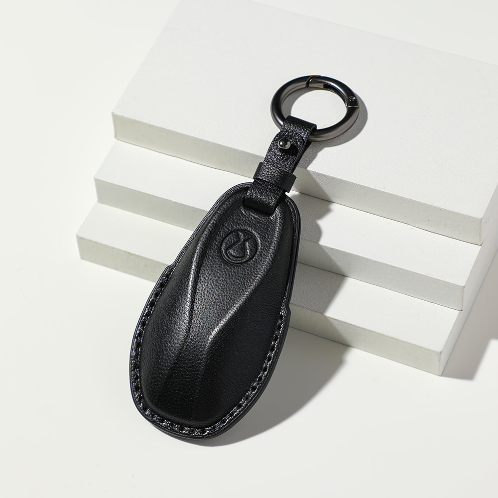 Premium black textured leather car key fob cover with protective stitching.