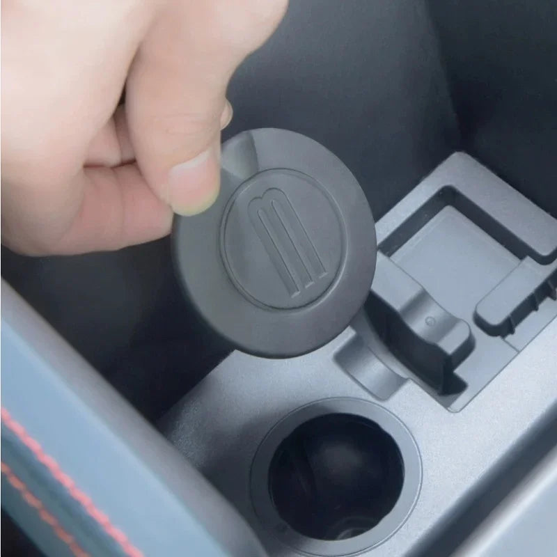 Black matte plastic center console organizer cover for BYD vehicle interior.