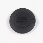 Matte black durable rubber charging port cover with embossed logo detail.