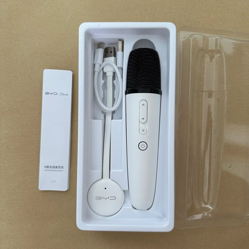 White BYD wireless microphone with black mesh head and USB charging cable in white packaging.
