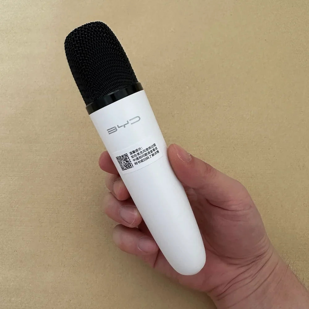 White handheld wireless microphone with a black mesh grille and BYD logo.