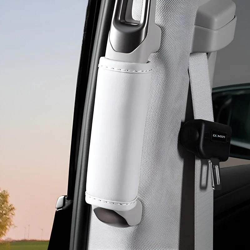 White leather seatbelt cover protecting the pillar in a vehicle interior.