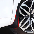 Black durable rubber mud flap installed on a white car wheel arch for protection.
