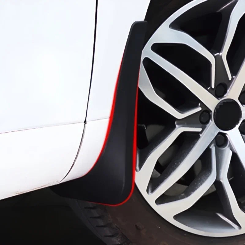 Black durable rubber mud flap installed on a white car wheel arch for protection.