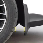Black durable matte mud flap installed behind the car tire for enhanced protection.