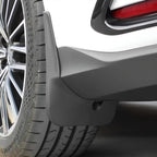 Durable matte black ABS plastic mud flap installed behind the rear wheel for vehicle protection.
