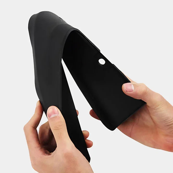 Hands holding a flexible, matte black silicone protective car accessory cover.