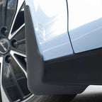 Black matte protective door edge guard installed on a light blue car body.
