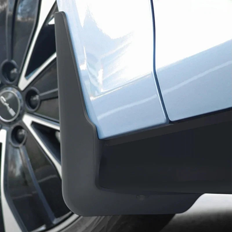 Black matte protective door edge guard installed on a light blue car body.