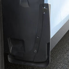 Durable matte black heavy-duty plastic mud flap installed on a vehicle side skirt.