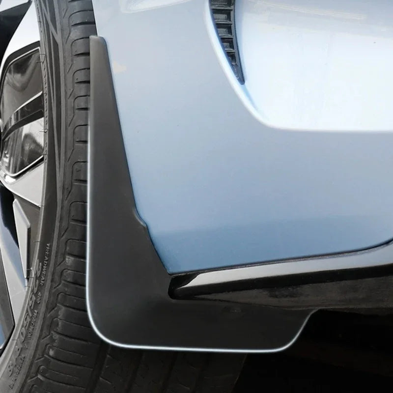 Black durable rubber mud flap installed on a light blue BYD car to protect against wear and tear.