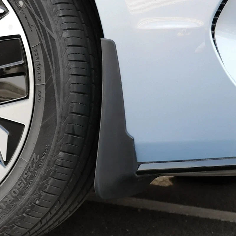 Black durable rubber mud flap installed behind the wheel of a light blue BYD car